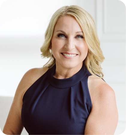 Portrait of a smiling blonde woman in a navy dress