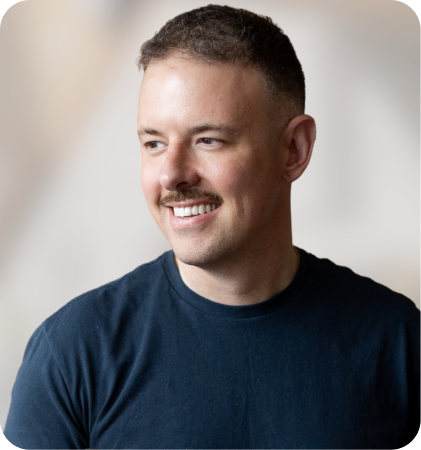 Portrait of a smiling man in a dark T-shirt looking to the side