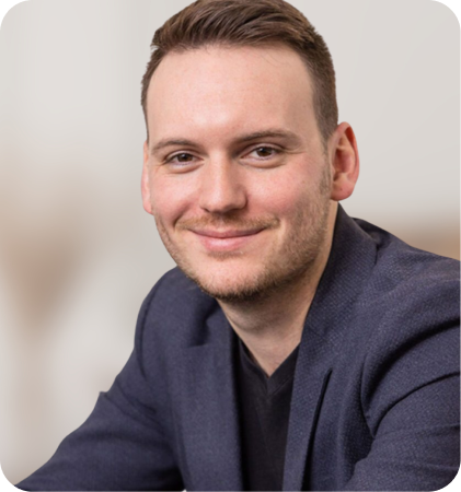 Portrait of a smiling man in a navy blazer and black shirt