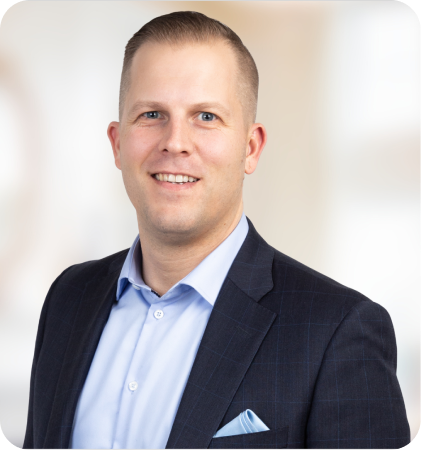 Portrait of a smiling man in a navy suit and light blue shirt