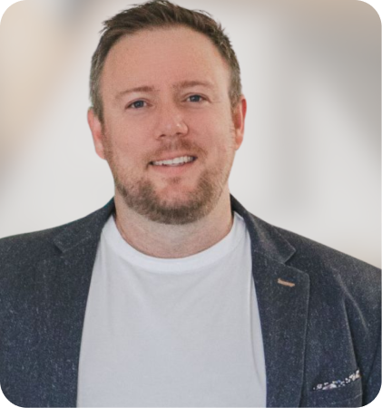 Portrait of a smiling man in a white shirt and dark blazer
