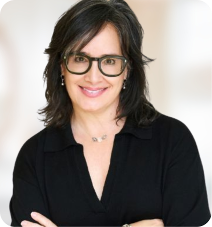 Portrait of a smiling woman with glasses wearing a black top